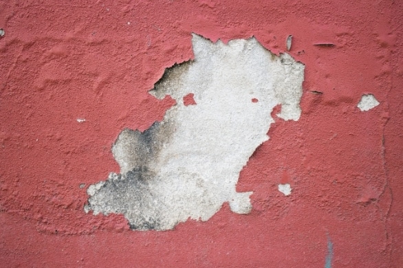 peeling stucco on side of building